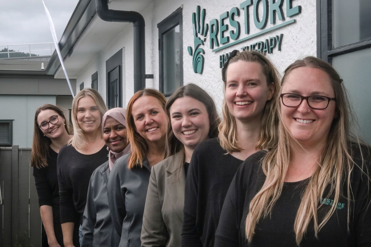 The Restore Hand Therapy team smiling together outside their Upper Hutt clinic